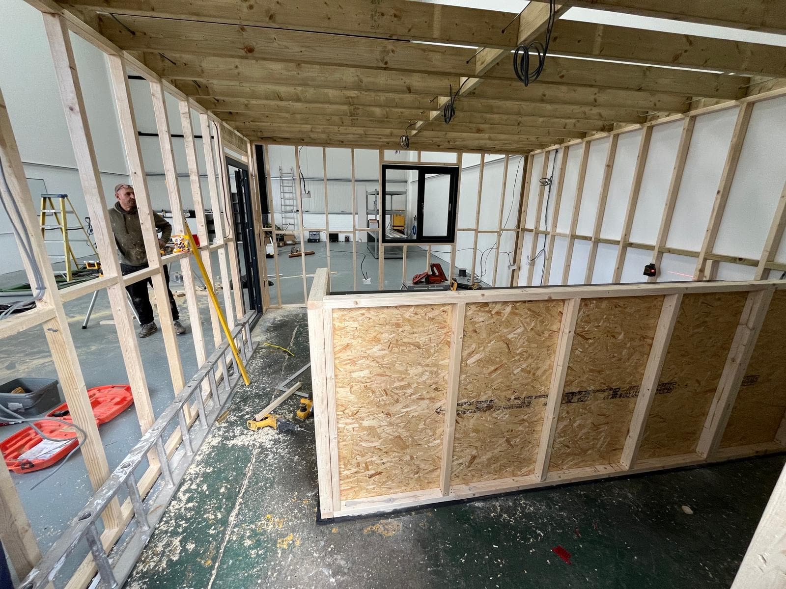 Inside the timber-framed office during the build, with the reception counter taking shape