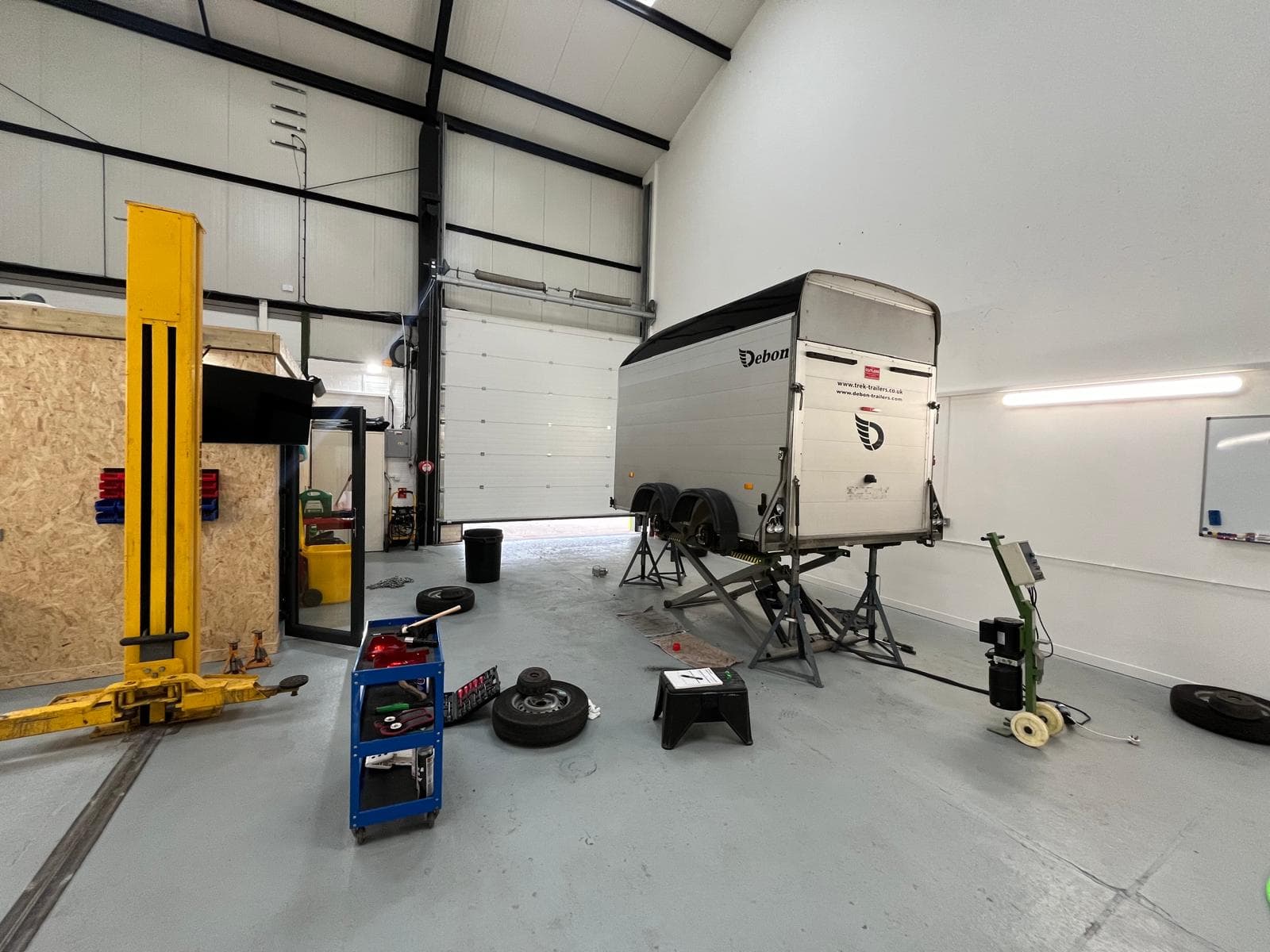 Debon box trailer up on the lift in the C&B workshop