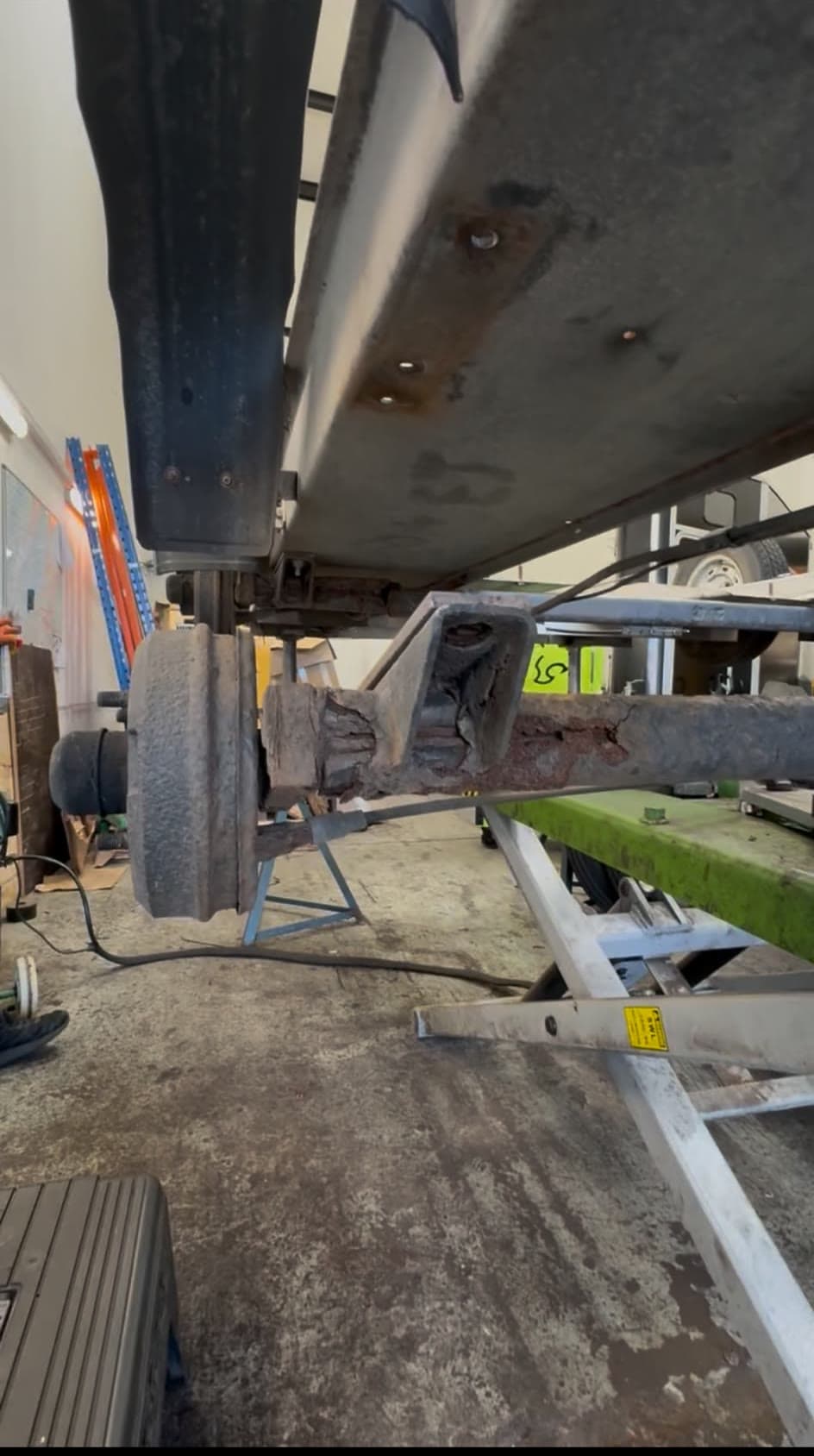 Badly corroded trailer axle, rusted through next to the hub