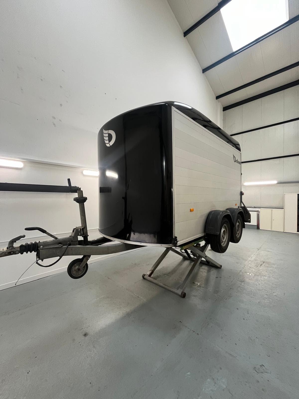 Debon box trailer raised on the scissor lift